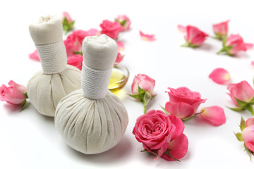 Fototapeta na wymiar Herbal compress balls for spa treatment with rose flower
