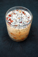 Chia seed pudding made with coconut flakes, goji berries and oats