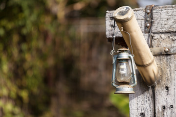 old lamp hanging on the wooden holder