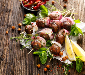 Kofta skewers, meatballs and red onion with addition of fresh mint and thyme,delicious  oriental...