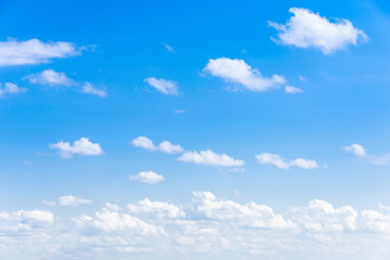 Naklejka na ściany i meble Clear blue sky with white fluffy clouds