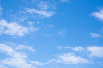 Clear blue sky with white fluffy clouds