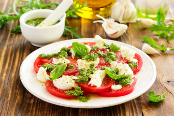Delicious salad of tomato, mozzarella and pesto.