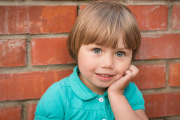 portrait of beautiful girl in red brick wall