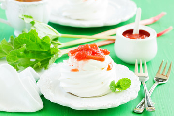 Dessert of meringue with rhubarb and mint sauce.