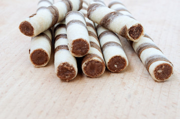 Biscuits wafer rolls on a wooden board