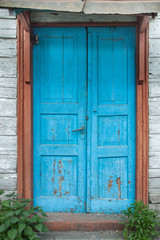 Fototapeta na wymiar An Aged weathered blue door.