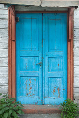 An Aged weathered blue door.