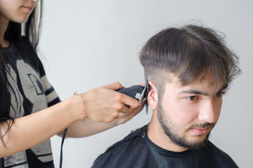 Men's hairstyling and haircutting in a barber shop or hair salon