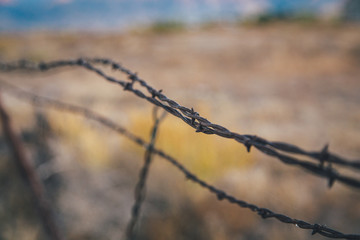 Barbed Wire against Western Landscape