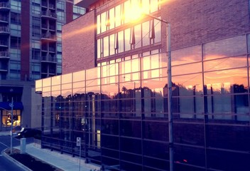 Fototapeta na wymiar Sunset reflection in modern building windows