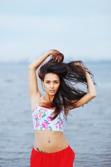 Naklejka premium Portrait of young beautiful woman wearing a t-shirt and red skir