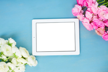 Pink and white ranunculus flowers on blue table styled flat lay scene, retro toned