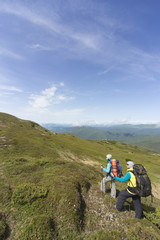 Obraz premium Summer hiking in the mountains with a backpack .