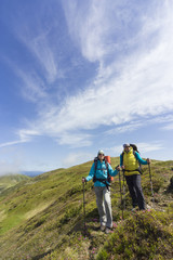 Obraz premium Summer hiking in the mountains with a backpack .