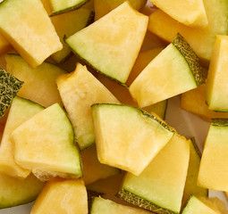 Hamigua Melon cut into slices, Hami Melon, Hami Cantaloupe isolated on white background.
