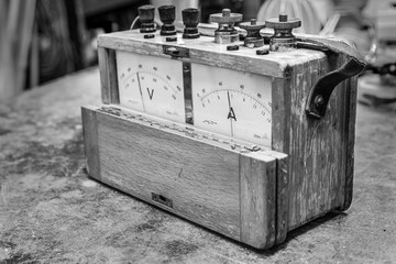 Vintage analog wooden electric meter on the old table test