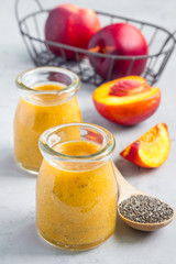 Smoothie with nectarine, orange juice, chia seeds and honey, vertical