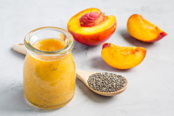 Smoothie with nectarine, orange juice, chia seeds and honey, horizontal
