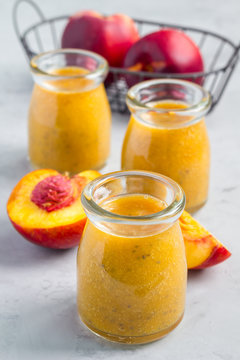 Smoothie with nectarine, orange juice, chia seeds and honey, vertical