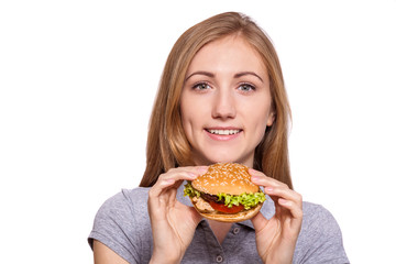 I'm taking this burger down! Beautiful young woman hold burger over white background.