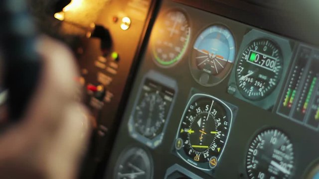 Flight control desk with changing indicators, pilot's hands on steering wheel