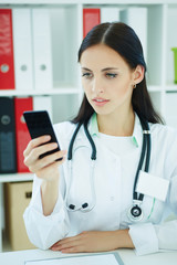 Portrait of a beautiful medical doctor making talephone call.