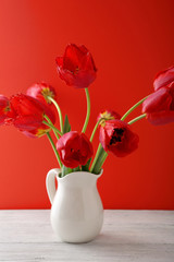 red tulips in  white vase