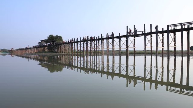People walk at U Bein Bridge longest teakwood bridge in the world