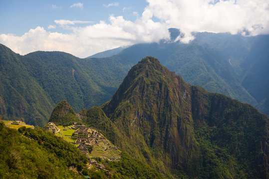 Machu Picchu archeological site and Wayna Picchu illuminated by the sunlight.