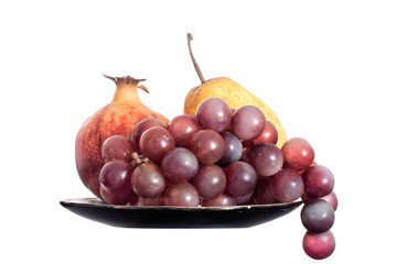 Grapes, pear and pomegranate isolated on white.