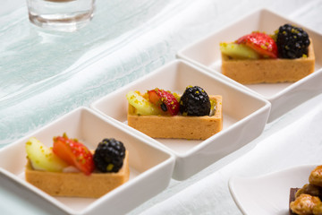 close up of square fruit tart in modern plate