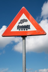 Dutch road sign: level crossing without barrier or gates ahead