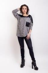 beautiful fashionable sexy girl in a dress for a catalog shoot on a white background