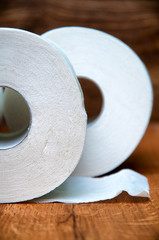 Toilet paper on wooden background