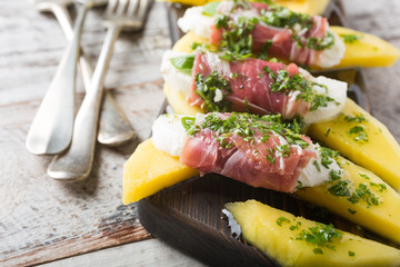 Rolls of mozzarella, basil and Parma ham