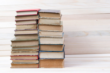 Stack of hardback books on wooden table. Back to school. Copy space