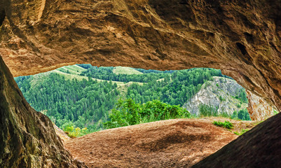 View from inside of cave on mountains and forest in Myradymovo, Bashkortostan, Russia