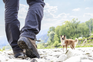 Traveller with the dog at the riverside