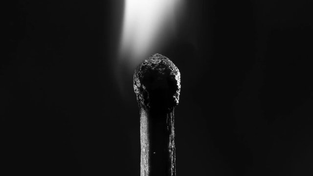 Ignition of a match on black background