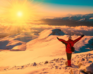 A man in mountain sunset winter. Unique. Sunny rays. Christmas