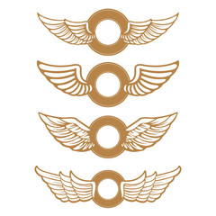 Set of the emblems with wings in gold style isolated on white ba