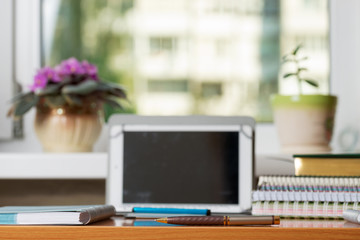 Office desk table with computer, supplies, flower. Copy space for text