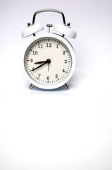 White alarm clock isolated on white background