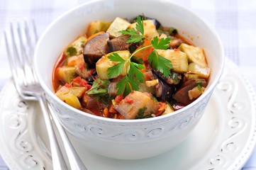 Vegetable stew of eggplant, zucchini, onions, carrots, tomatoes, garlic and parsley