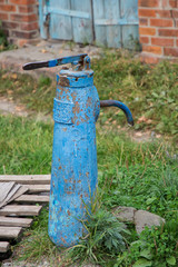 Old rusted public water tap, column.