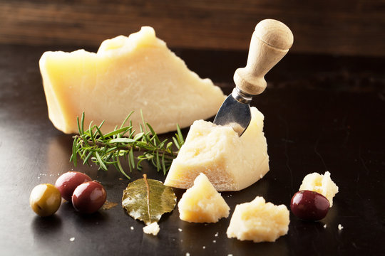 Parmesan cheese with olives and rosemary