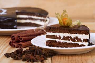 Chocolate cake with winter cherry on a plate