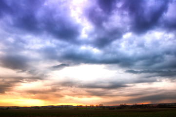 Fototapeta na wymiar Storm dark clouds over meadow