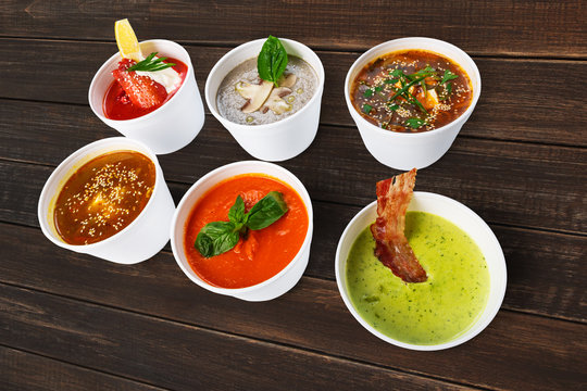 Variety of soups from different cuisines at brown wood